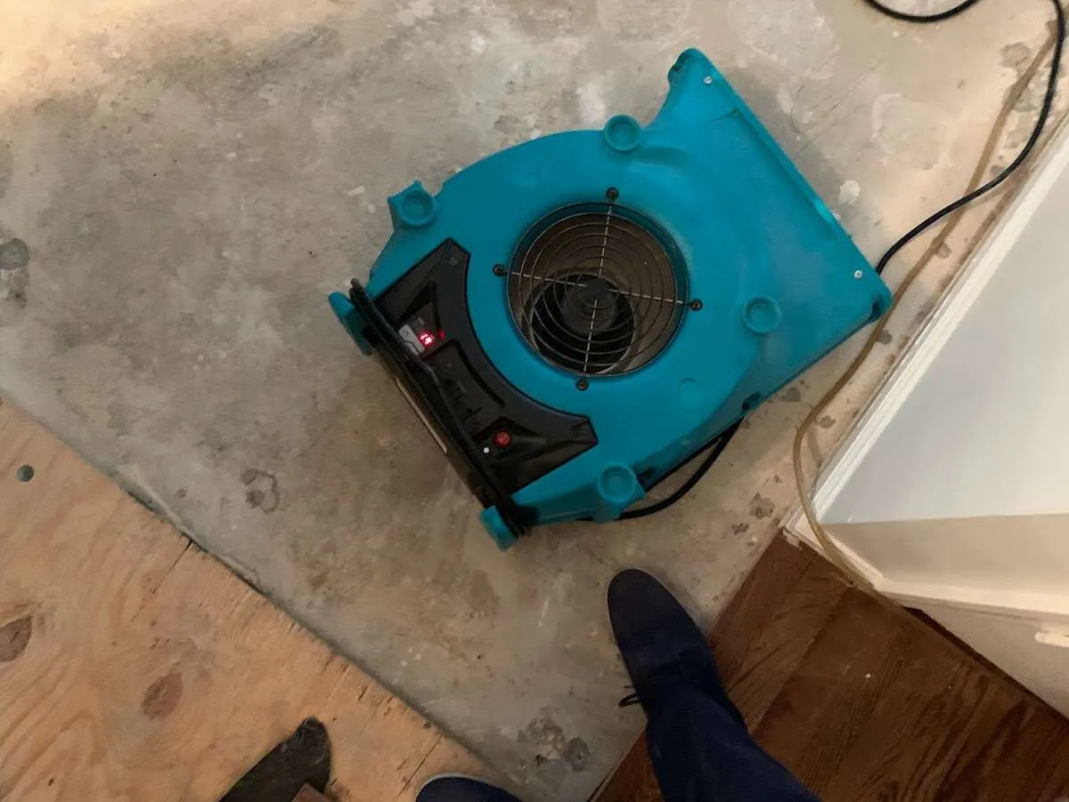 Air mover drying subfloor during Commercial Water Damage Restoration in Richfield